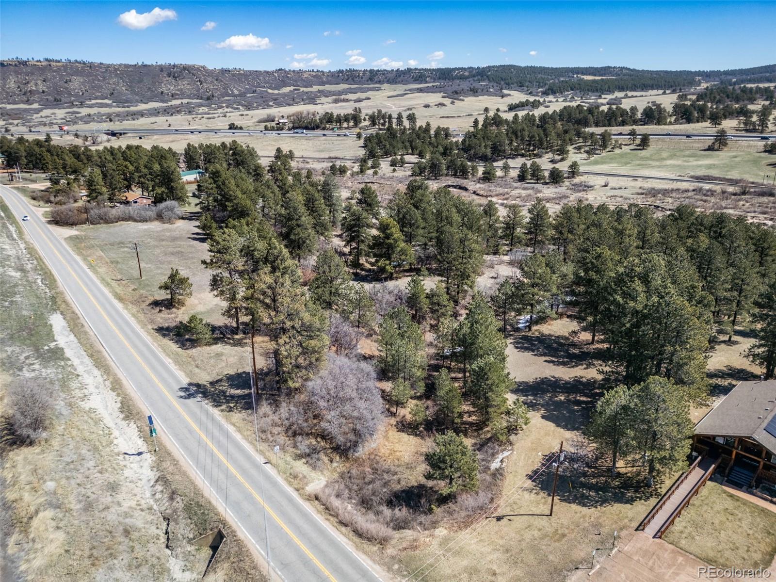 8650 Spruce Mountain Road Larkspur, CO 80118 - Photo 4 of 12 a view of a city and ocean