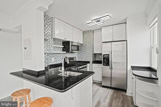 a view of an empty room and wooden floor