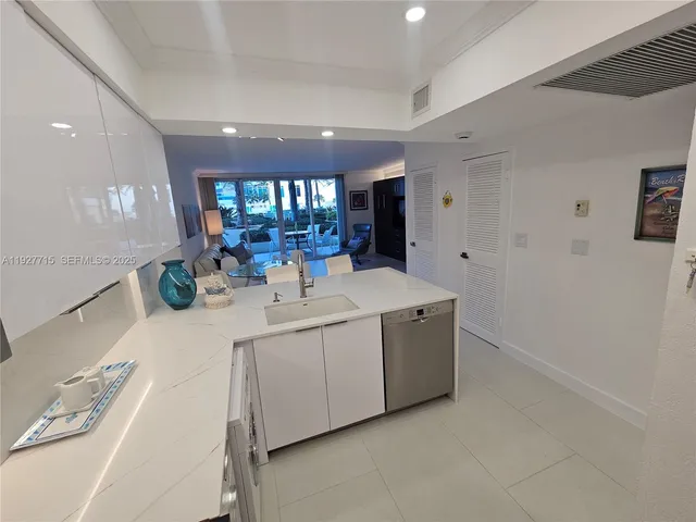 a large white kitchen with a large window