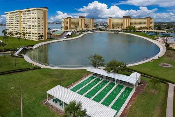 a view of a swimming pool with lawn chairs