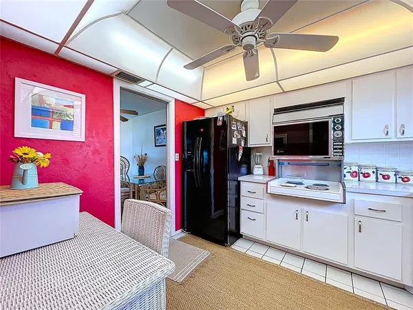 a kitchen with stainless steel appliances kitchen island granite countertop a refrigerator and microwave