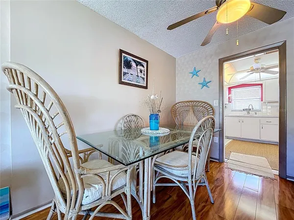 a view of a dining room with furniture and chandelier