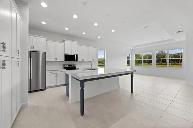 a living room with furniture kitchen view and a table