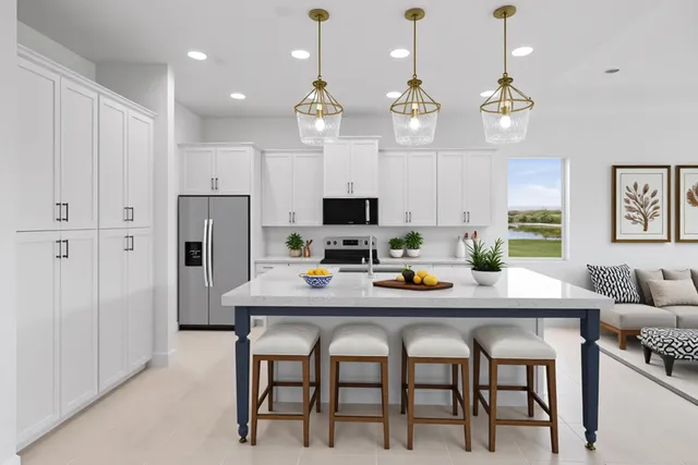 a view of an empty room with window and a kitchen view
