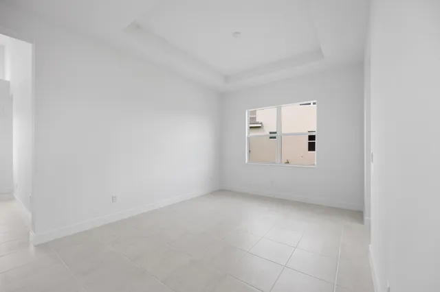 an empty room with windows and cabinet