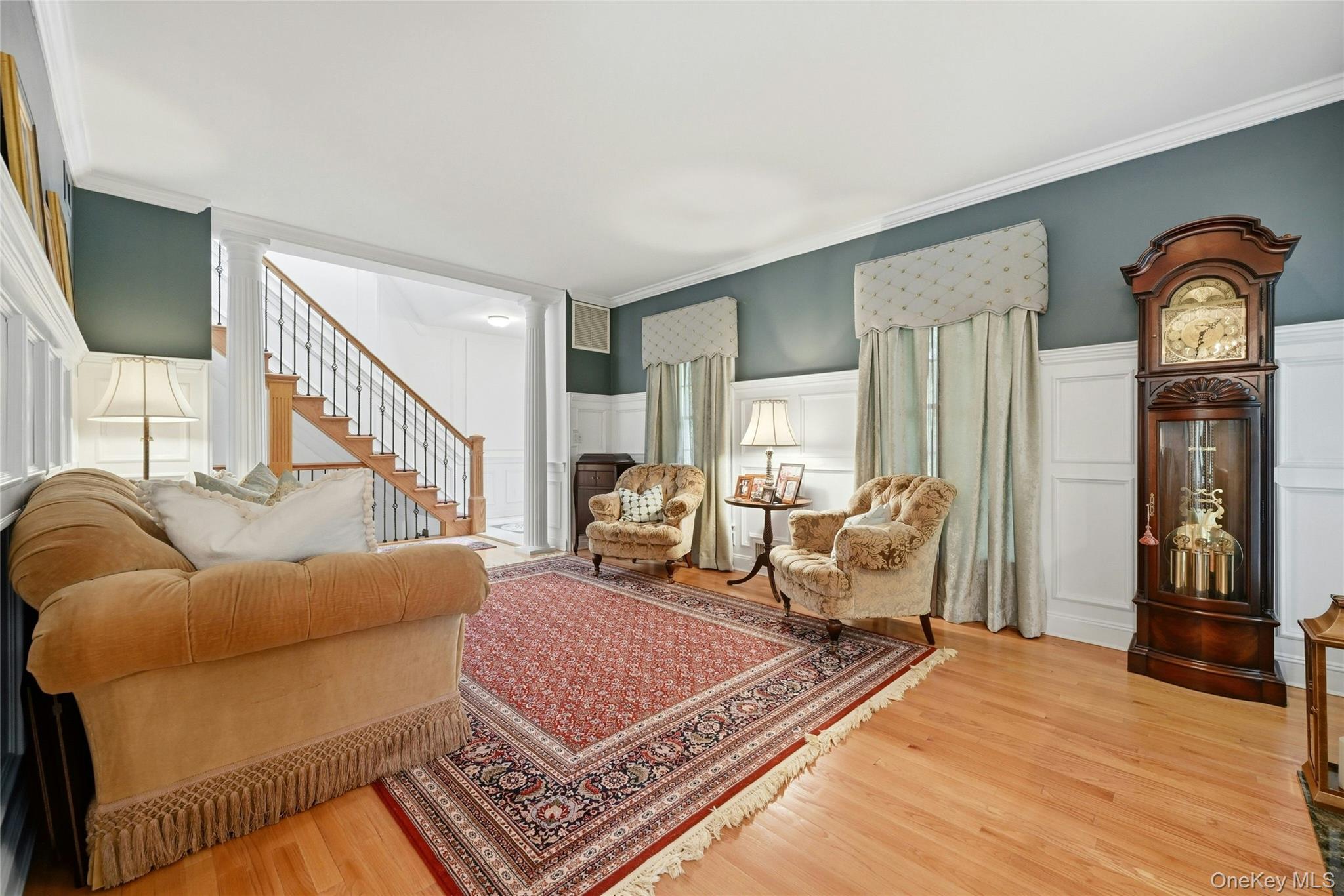 6 Thunder Road Miller Place, NY 11764 - Photo 14 of 50 The Elegant, Stunning Formal Living Room Offers A Two Columned Entrance, Spectacular 6' Box Paneled/Wainscoted Walls, Magnificent Focal Point Wood Burning Fireplace With A Custom Floor To Ceiling Wood Mantel, Marble Surround & Base Flanked By Exquisite Stained Glass Windows, 9' Ceilings With Oversized Andersen Windows, Custom Moldings, Hardwood Floors & A Beautiful Custom Archway (Also With Beautiful Moldings/Trims) Into The Formal Dining Room.