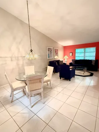 a bedroom with a bed and large windows