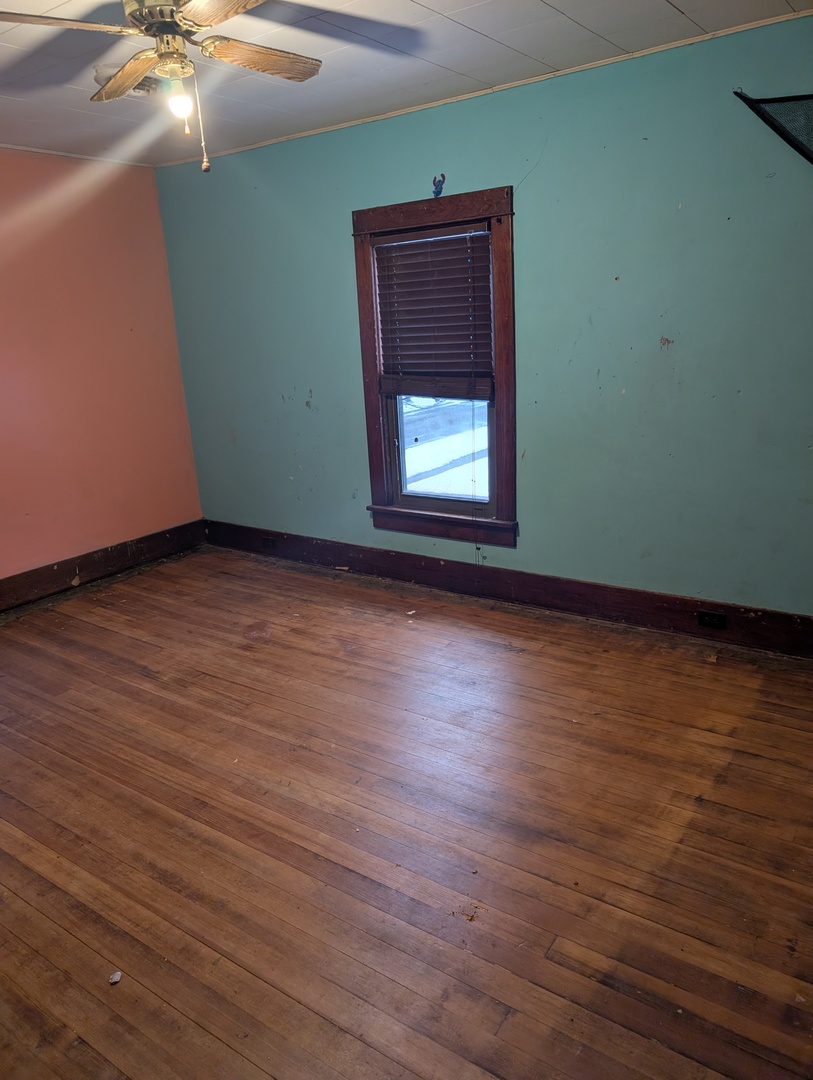 101 South Pine Street Buckley, IL 60918 - Photo 15 of 20 a view of an empty room with wooden floor and a window
