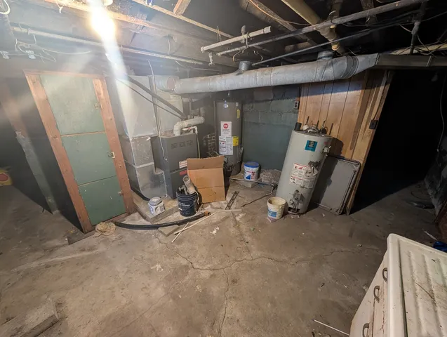 a view of a storage room with water heater and racks