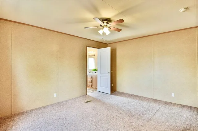 a bathroom with a granite countertop sink a mirror and a shower