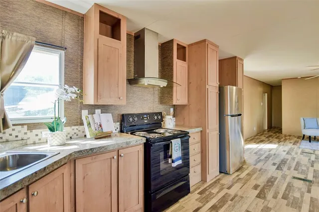 a kitchen with a refrigerator and a sink