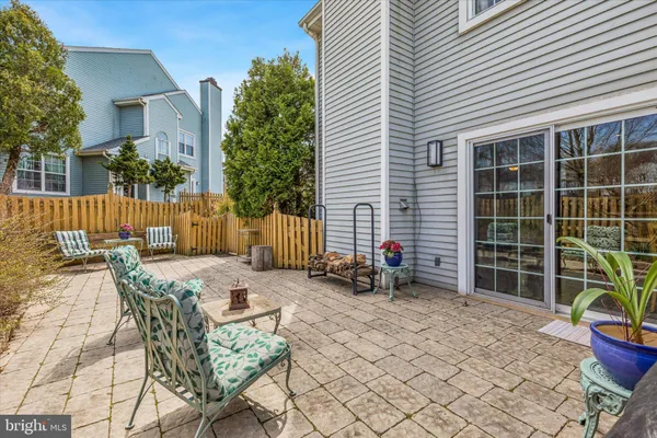 a view of a patio with table and chairs and potted plants