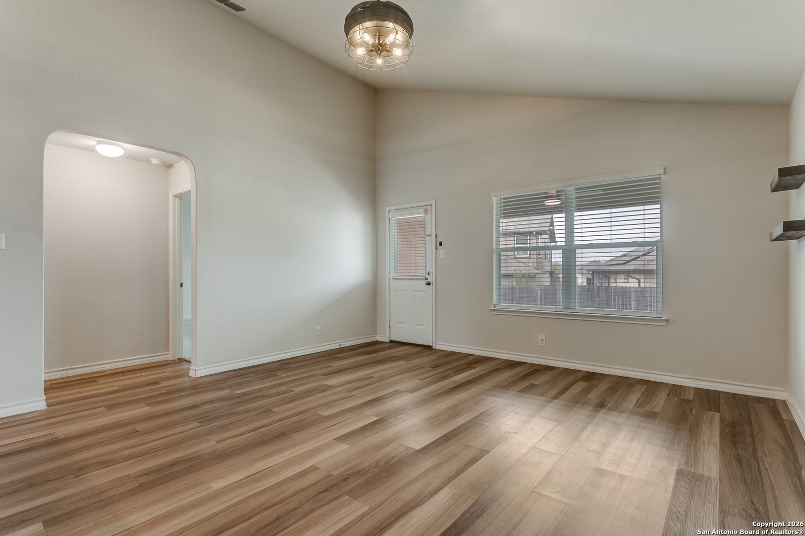 2615 Yaupon Ranch San Antonio, TX 78244 - Photo 13 of 25 an empty room with wooden floor and windows