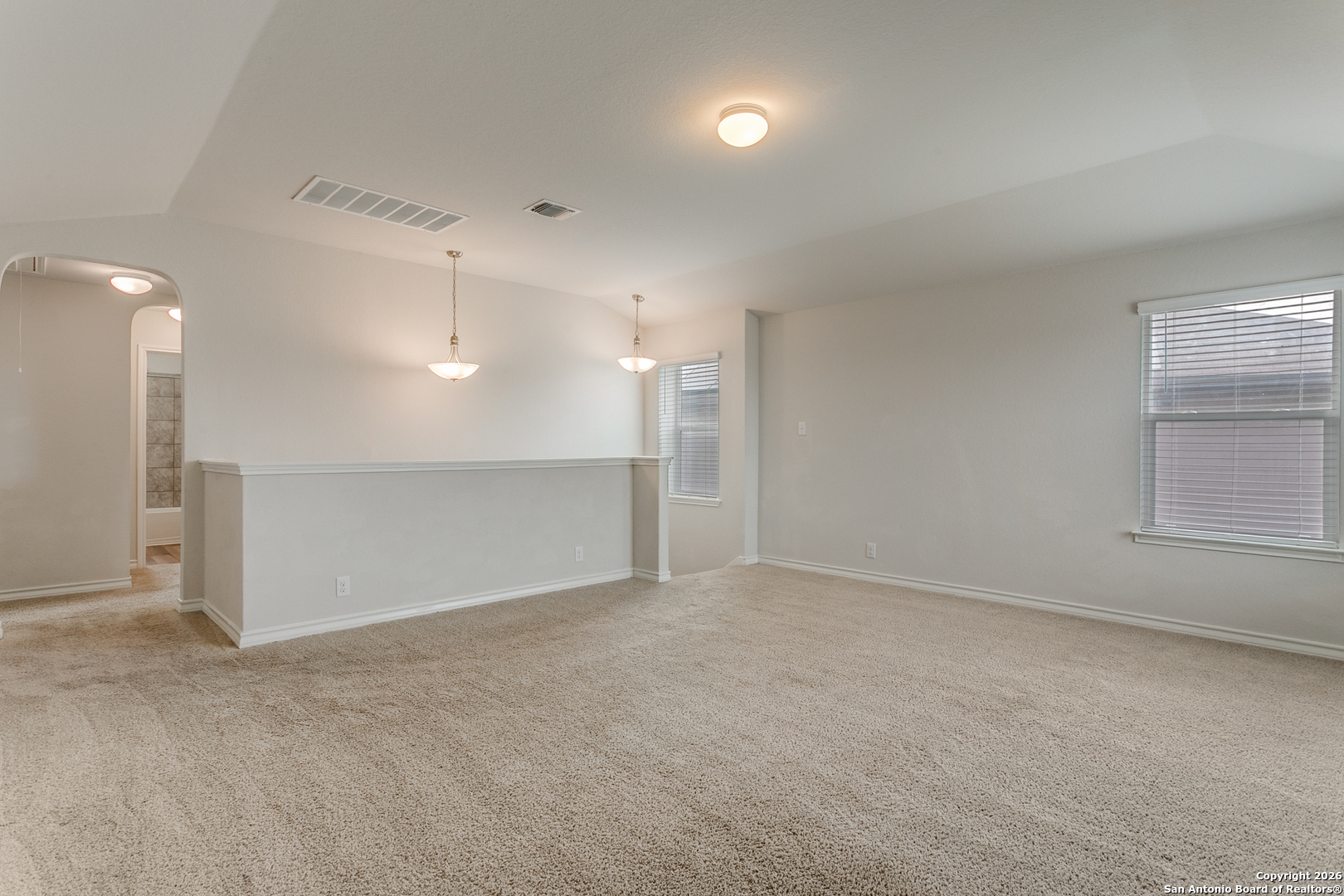 2615 Yaupon Ranch San Antonio, TX 78244 - Photo 17 of 25 an empty room with windows and pillars in it