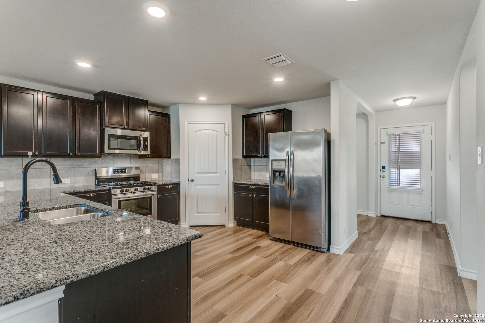 2615 Yaupon Ranch San Antonio, TX 78244 - Photo 7 of 25 a kitchen with stainless steel appliances granite countertop a refrigerator microwave and stove