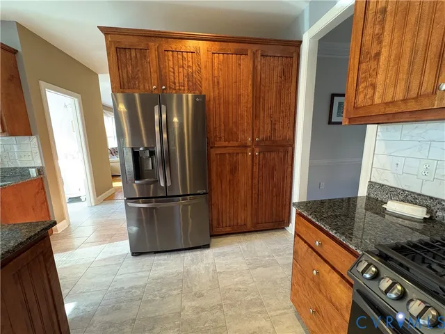 a kitchen with stainless steel appliances granite countertop a refrigerator and a sink