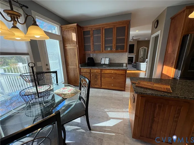 a kitchen with a table chairs and refrigerator