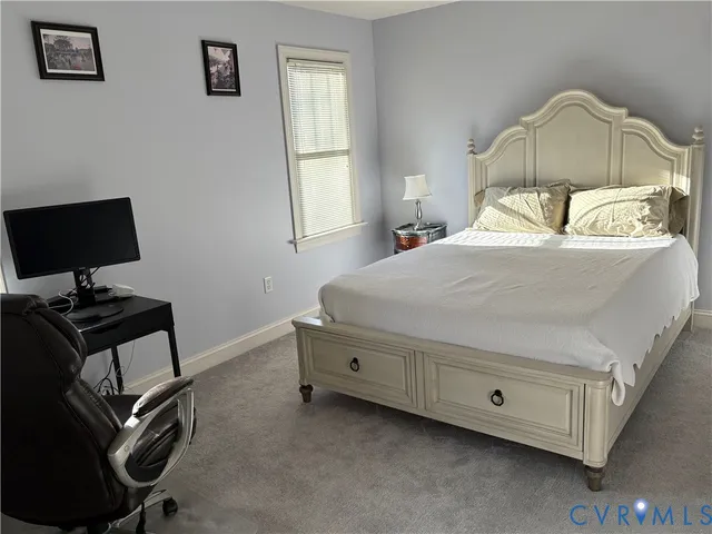 a bedroom with a bed a table and chair