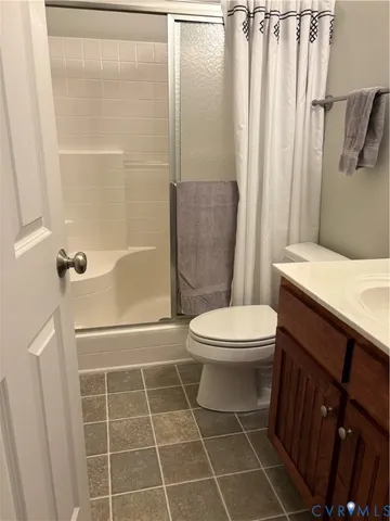 a bathroom with a toilet a sink and a shower