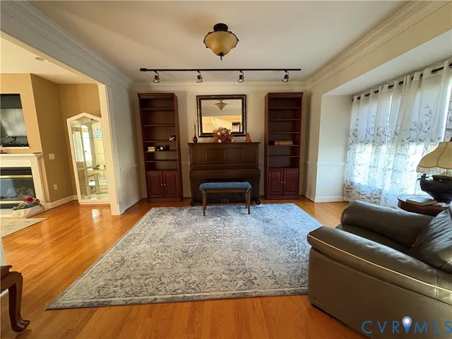 a living room with furniture and a wooden floor