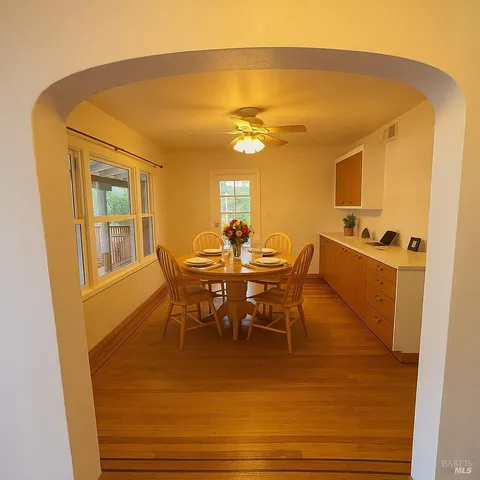a view of a dining room with furniture and a chandelier