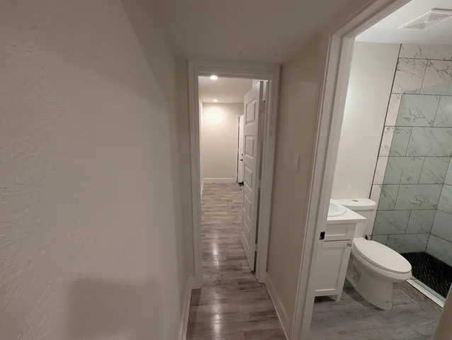 a bathroom with a toilet and a shower