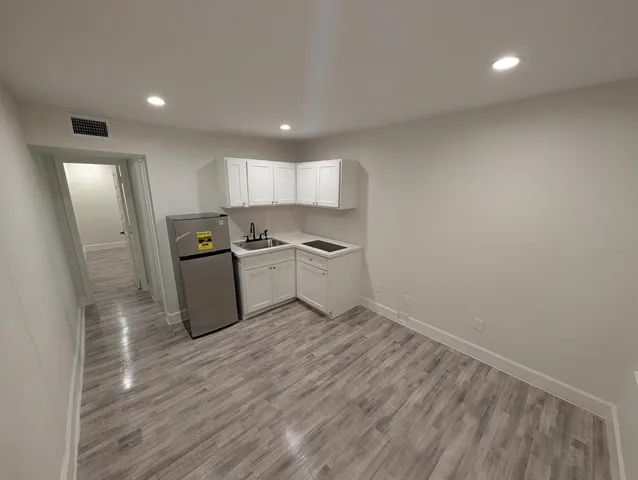 a view of kitchen with wooden floor