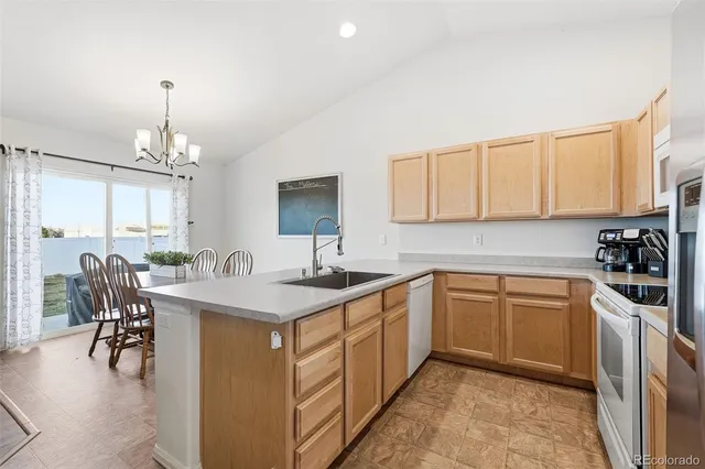 a kitchen with a sink stove and cabinets