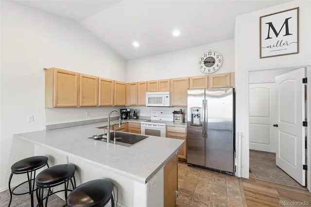a kitchen with a refrigerator a stove a sink and a cabinets
