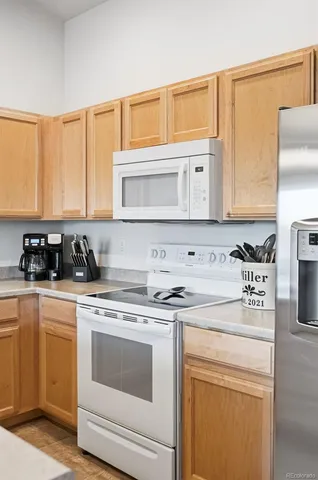 a kitchen with stainless steel appliances granite countertop a sink and a stove