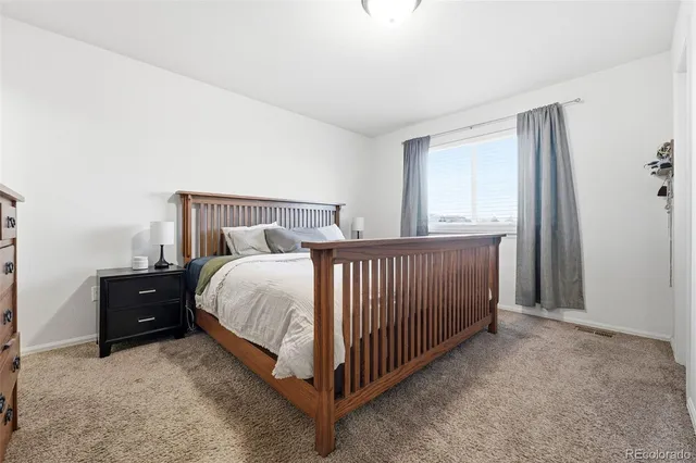 a bed room with a bed and a window