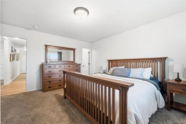 a bedroom with bed and a dresser