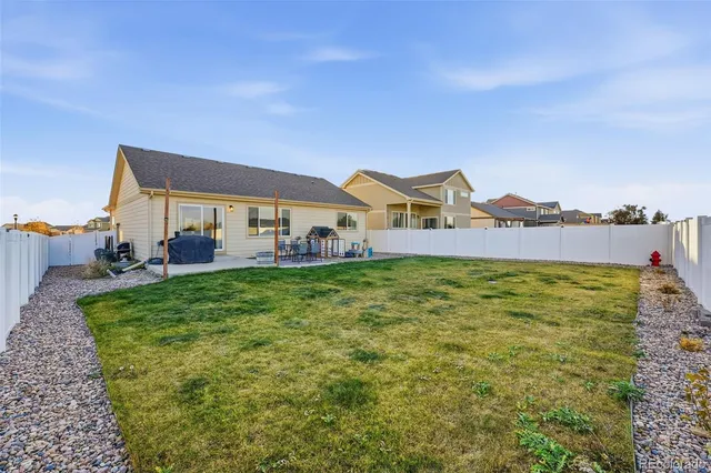 a view of a big house with a big yard and large trees