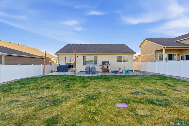 a view of backyard of house and green space