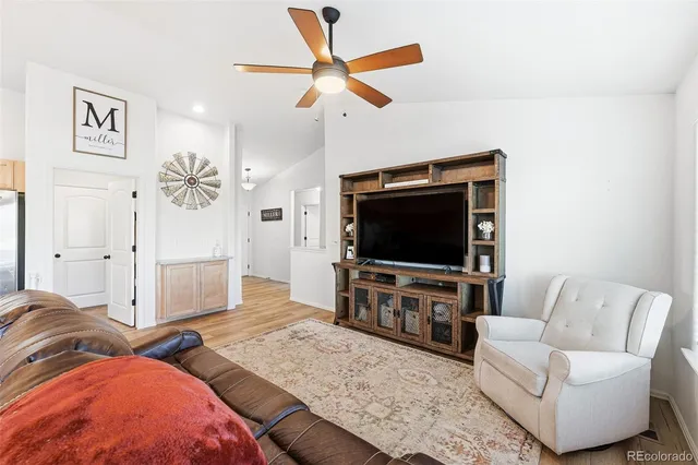 a bedroom with furniture and a flat screen tv