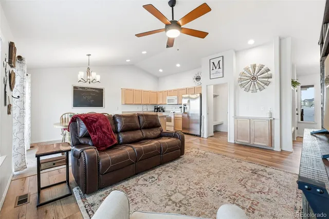 a living room with furniture and a chandelier
