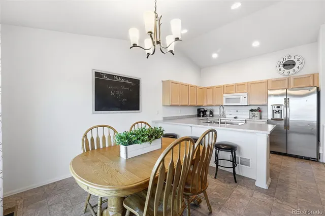a dining room with furniture and chandelier