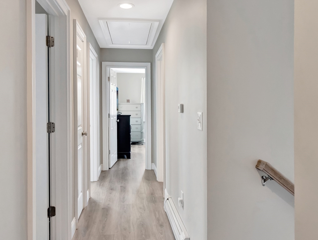 47 B Street, Unit BEACHSIDE Hull, MA 02045 - Photo 23 of 42 a view of a hallway with wooden floor and a bathroom
