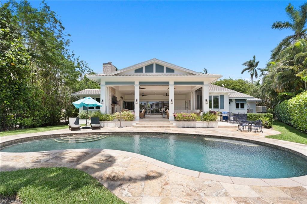 2201 Beacon Lane Naples, FL 34103 - Photo 6 of 25 a view of a house with sitting area and swimming pool