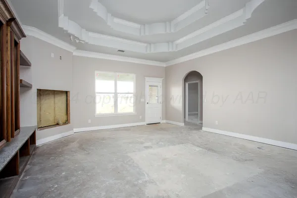 an empty room with windows and bathroom view