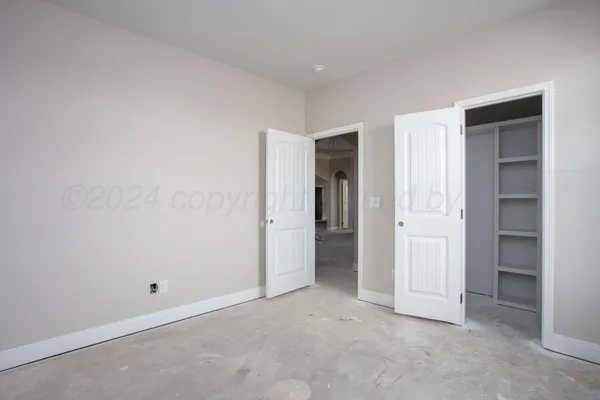 a view of an empty room and closet