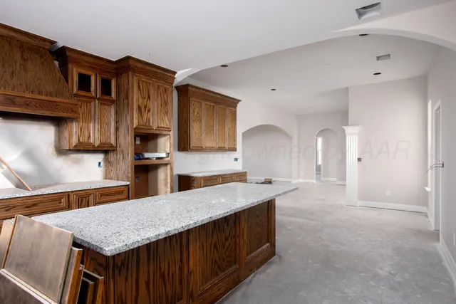 a kitchen with stainless steel appliances granite countertop a sink dishwasher stove and oven
