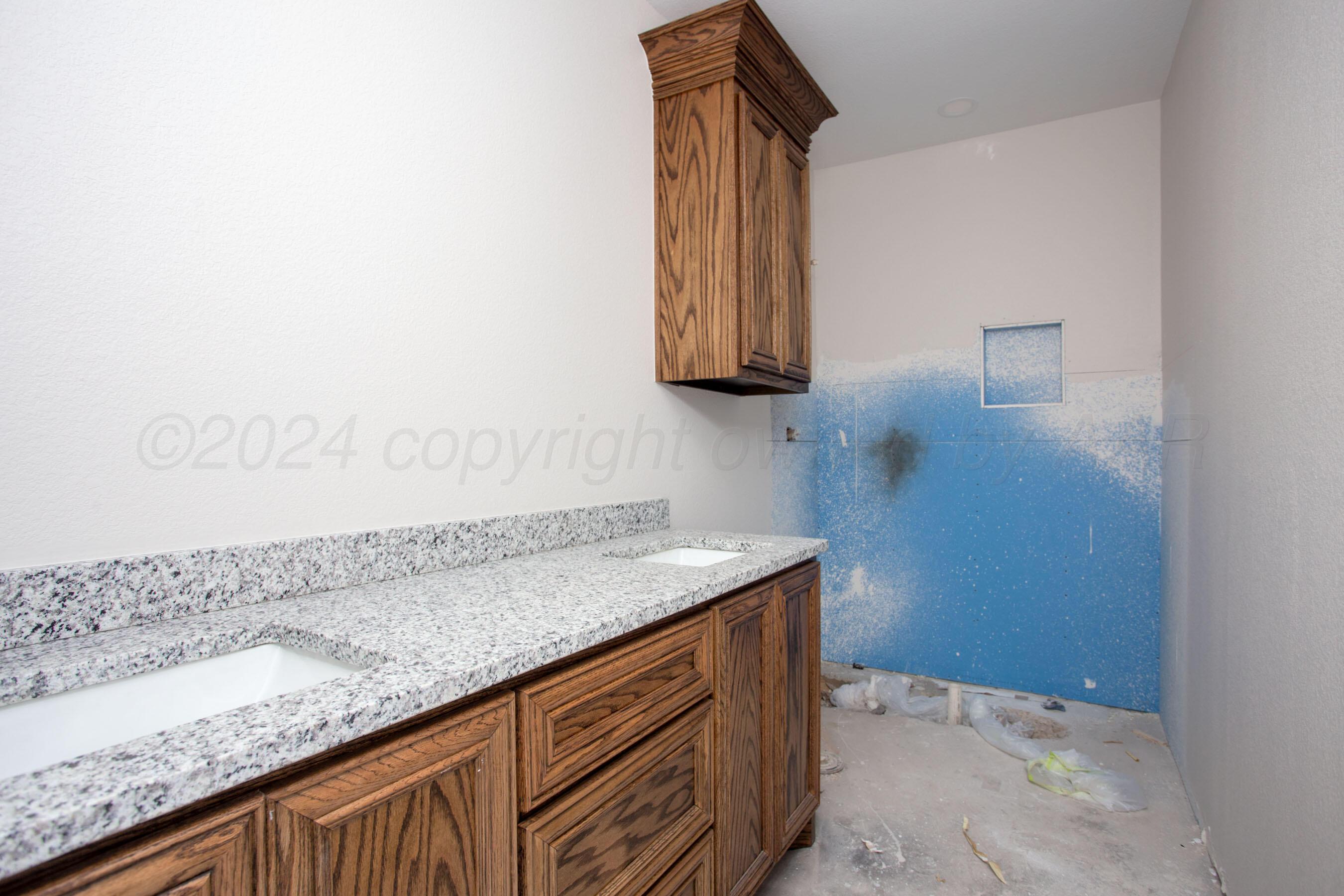 14540 Periwinkle Drive Amarillo, TX 79119 - Photo 5 of 24 a bathroom with a granite countertop sink and a mirror