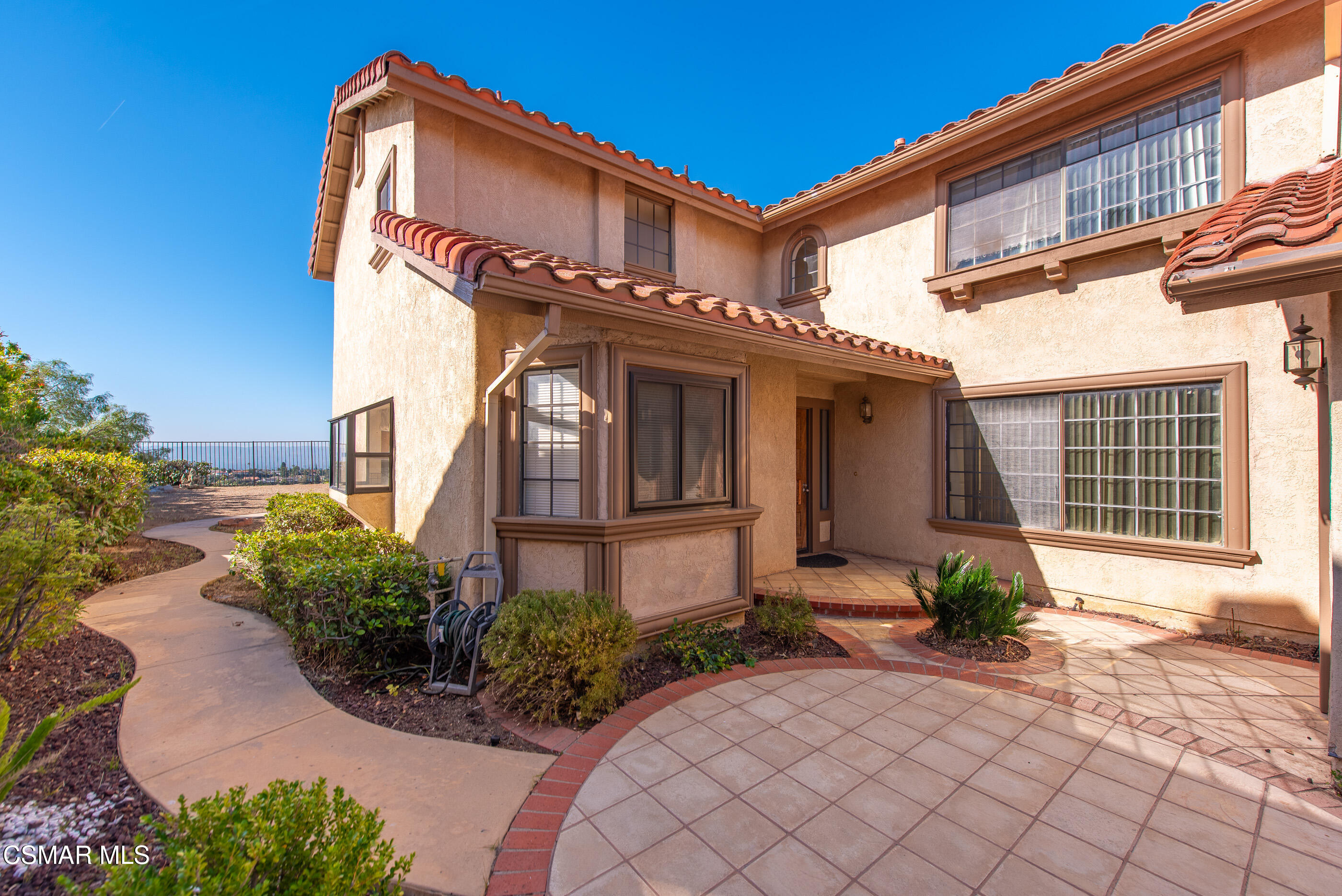 12036 Shadow Ridge Way Porter Ranch, CA 91326 - Photo 6 of 35 a front view of a house with garden