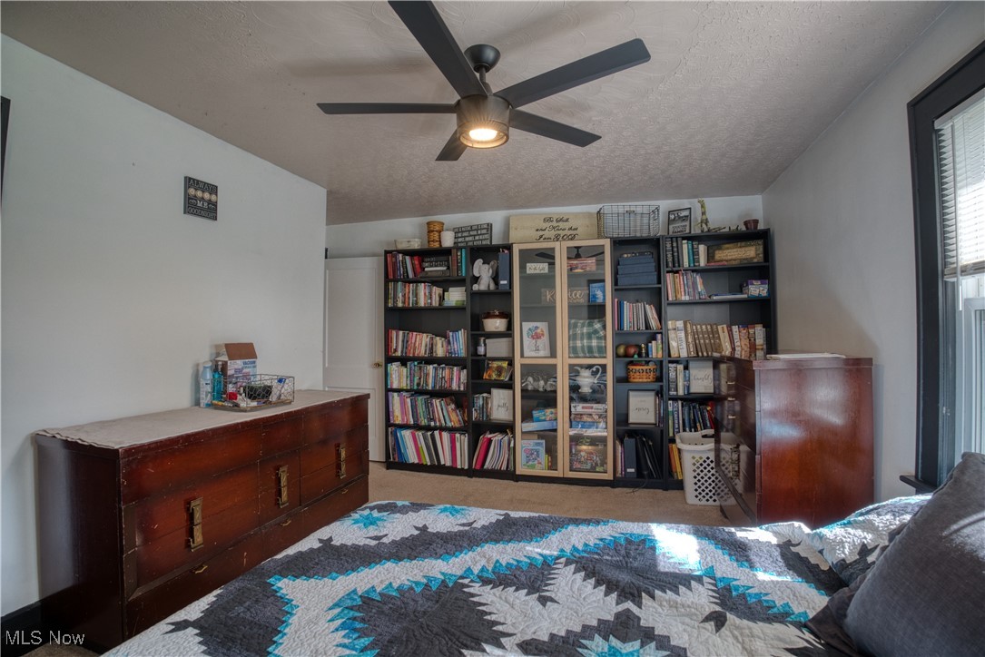 2161 Canton Road Akron, OH 44312 - Photo 17 of 33 Carpeted bedroom with a textured ceiling and a ceiling fan