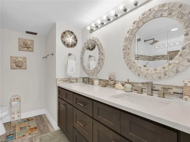 a bathroom with a double vanity sink and a mirror