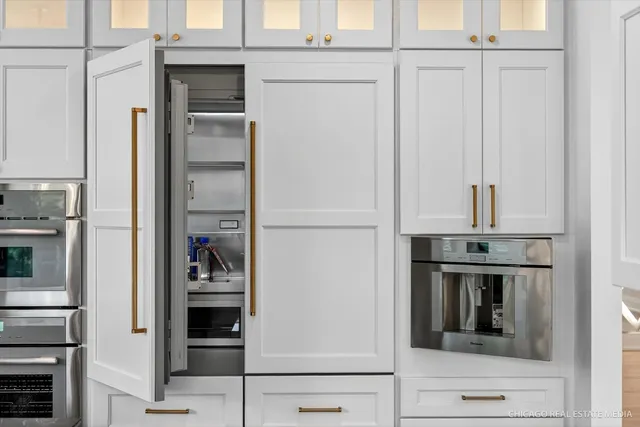 a view of hallway with a large window and wooden floor