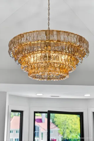 a view of a livingroom with wooden floor and a large window