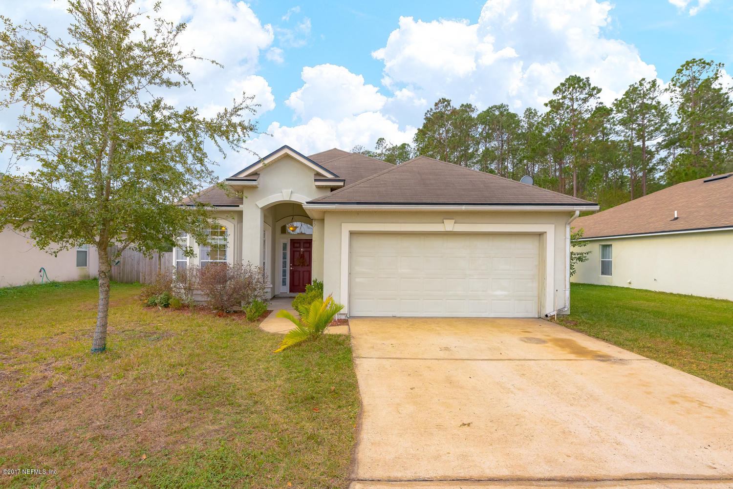 9170 Raptor Drive Jacksonville, FL 32221 - Photo 1 of 31 a front view of a house with a yard and garage