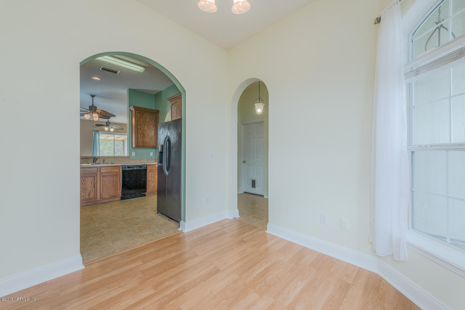9170 Raptor Drive Jacksonville, FL 32221 - Photo 12 of 31 a view of a hallway with wooden floor and a living room
